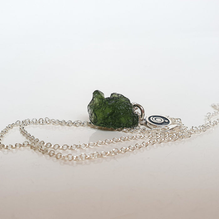 Necklace with a green stone pendant on a white background