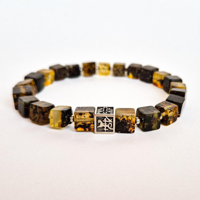 A bracelet featuring polished Baltic amber beads and a handcrafted silver charm with the 'Vytis' symbol.