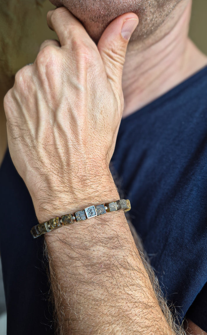 Close-up of a person wearing a bracelet on their wrist with a blurred background
