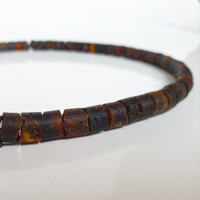 Brown amber beaded necklace on a white background