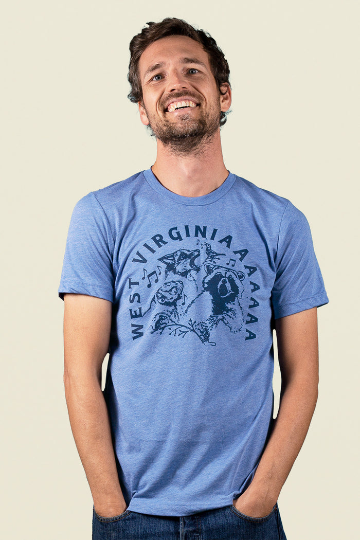Kin Ship Goods heather blue country critters tee with howling Appalachian animals and ‘West Virginiaaaaa’ text, perfect for nature lovers and locals.