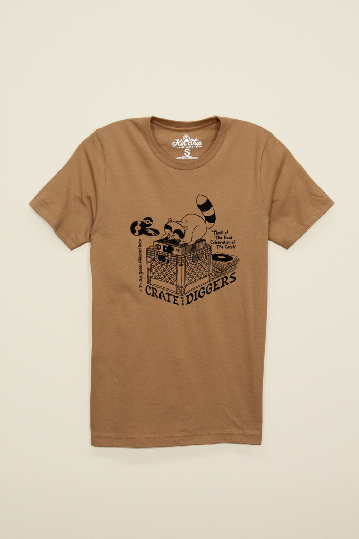 Kin Ship Goods brown unisex tee with raccoon crate-digging vinyl record graphic and ‘Crate Diggers’ retro-style text.