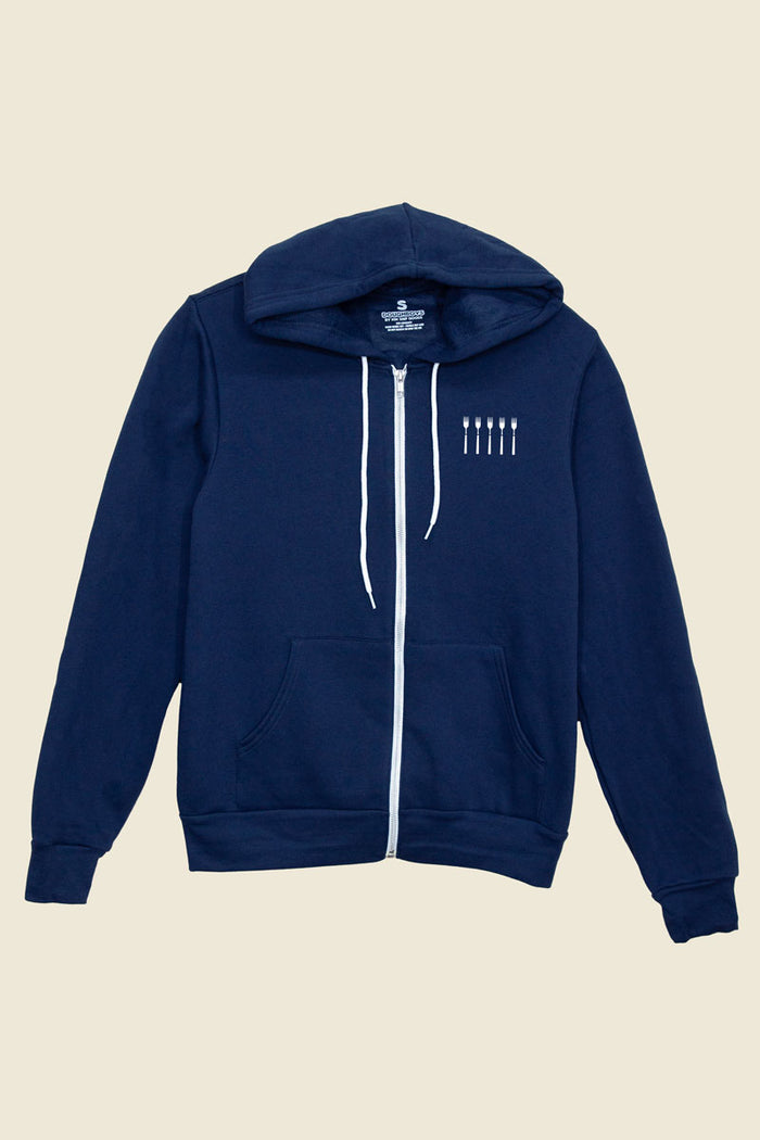 Navy zip-up Kin Ship Goods hoodie with small white fork design on chest, white drawstrings and zipper, laid flat on neutral background.