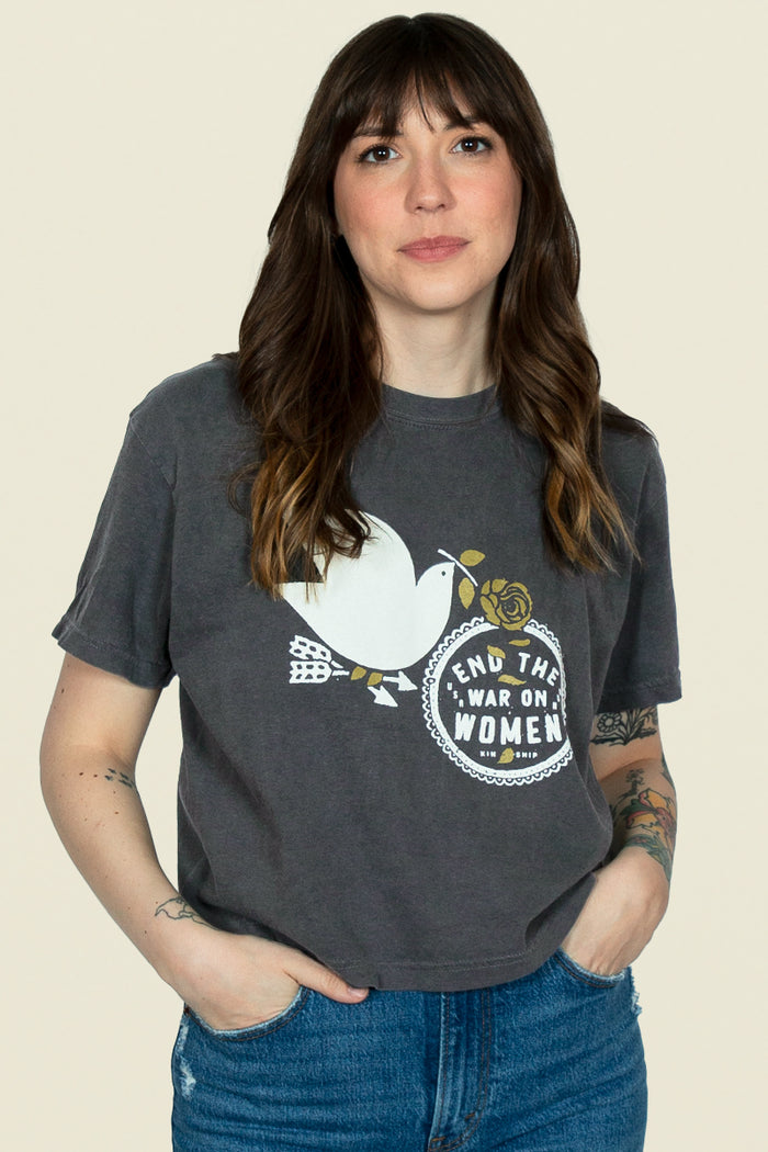 End the War on Women cropped tee from Kin Ship Goods – vintage-wash black shirt featuring a peace dove and bold feminist message. Ethically made.