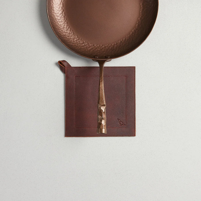 Full grain leather potholder from Smithey Ironware's 2305 POTHOLDERS collection, showing durable leather with stitched edges.