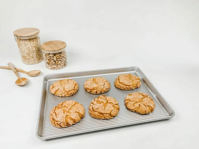 USA Pan Half Sheet Baking Pan with aluminized steel construction and non-stick coating, ideal for baking cookies and sheet cakes.