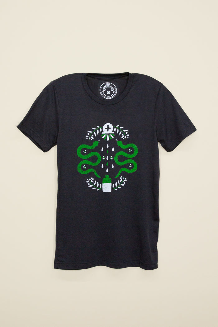Kin Ship Goods black tee with modern hex sign design featuring green snakes, leaves, and potion bottle—symbolizing protection, strength, and healing.