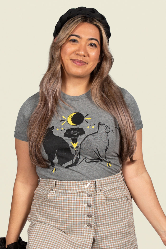 Kin Ship Goods heather gray t-shirt with two cats, moon phases, and folk-inspired hex symbols for protection, strength, and healing.