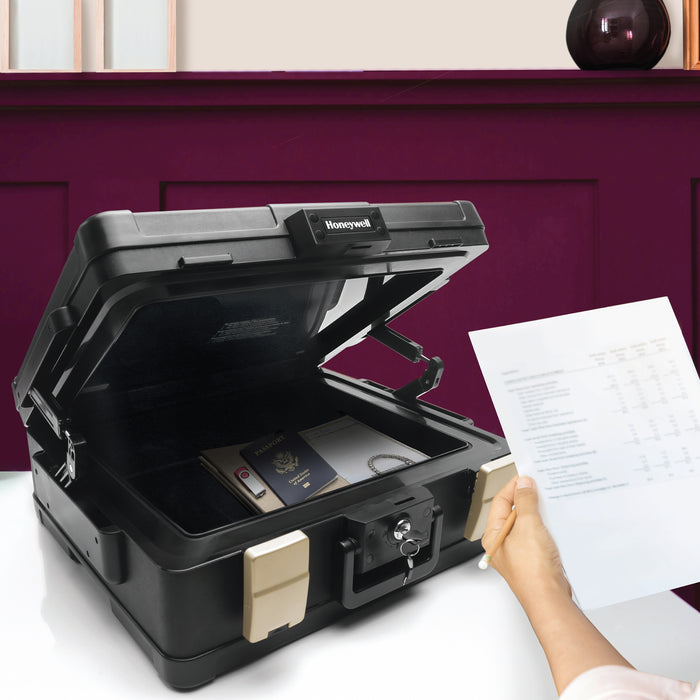 Honeywell 1104 Large One Hour Fire & Water Security Chest Door Open with Contents and Person holding paper with purple wall in background