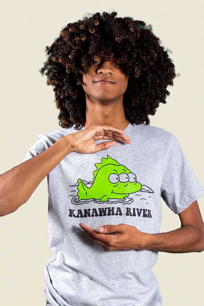 Kin Ship Goods gray tee with cartoon green fish and text reading 'Kanawha River,' inspired by local Charleston river lore.