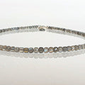 beaded necklace on a white surface