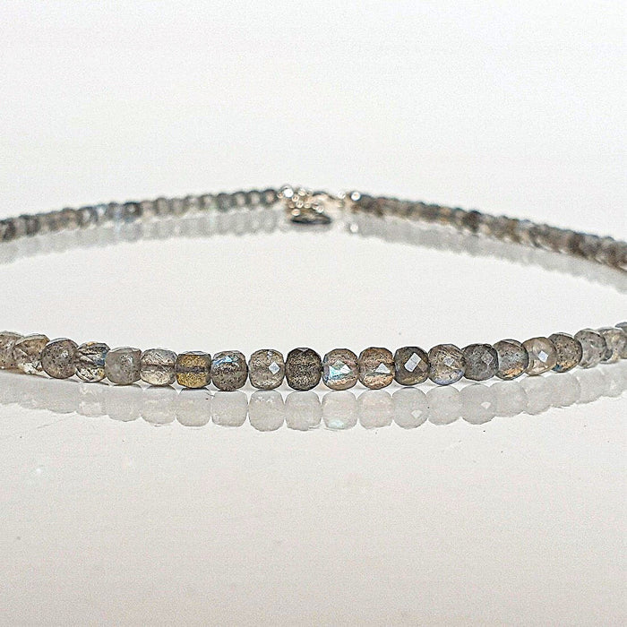 beaded necklace on a white surface