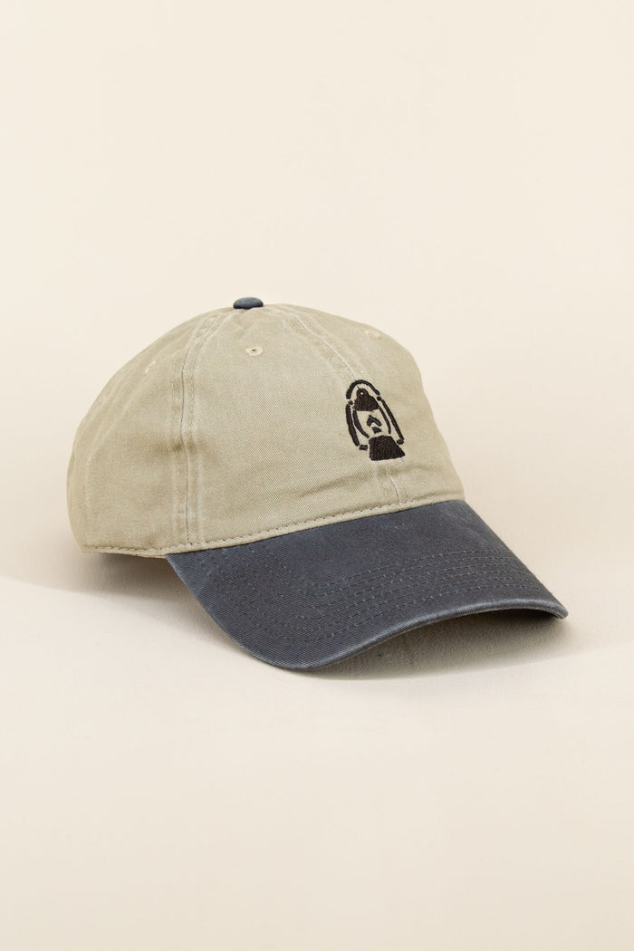 Khaki and black Kin Ship Goods baseball cap with black embroidered lantern graphic, angled on neutral background.