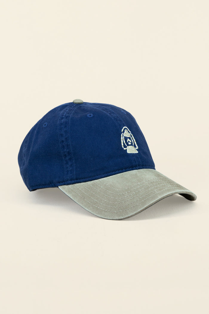 Kin Ship Goods lantern hat with navy crown and khaki brim—embroidered Appalachian lantern logo on classic cotton dad cap.