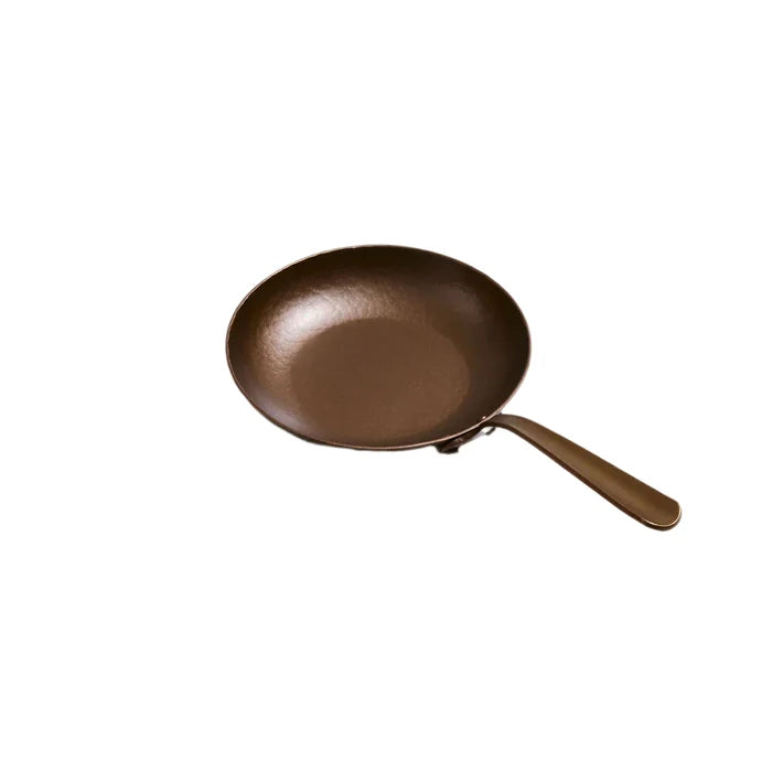 Smithey Ironware 9-inch Little Farmhouse Skillet, cast iron frying pan with smooth black finish and sturdy handle.