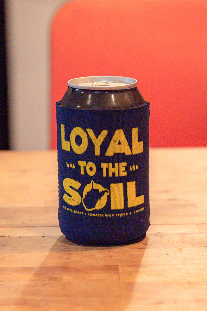 Kin Ship Goods “Loyal to the Soil” koozie with yellow West Virginia graphic on navy background—Appalachian pride drink holder.