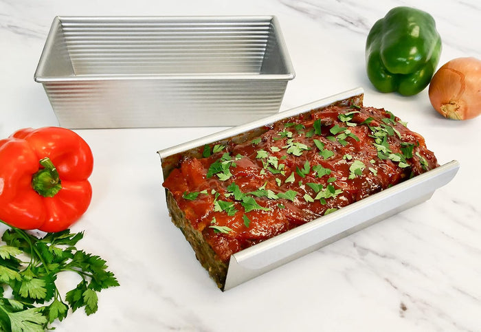 USA Pan Meat Loaf Pan with insert for baking, non-stick coating, heavy-duty metal construction, ideal for meatloaf and loaf-shaped dishes.