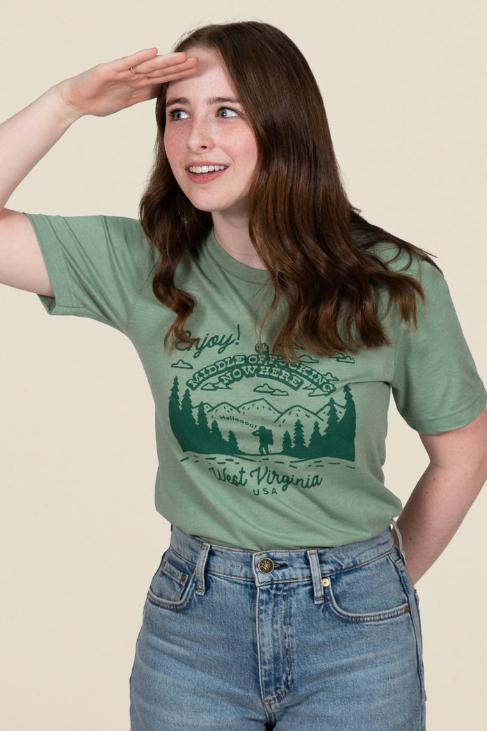 Kin Ship Goods green tee with forest scene and ‘Middle of Nowhere, West Virginia USA’ graphic, perfect for outdoor lovers.