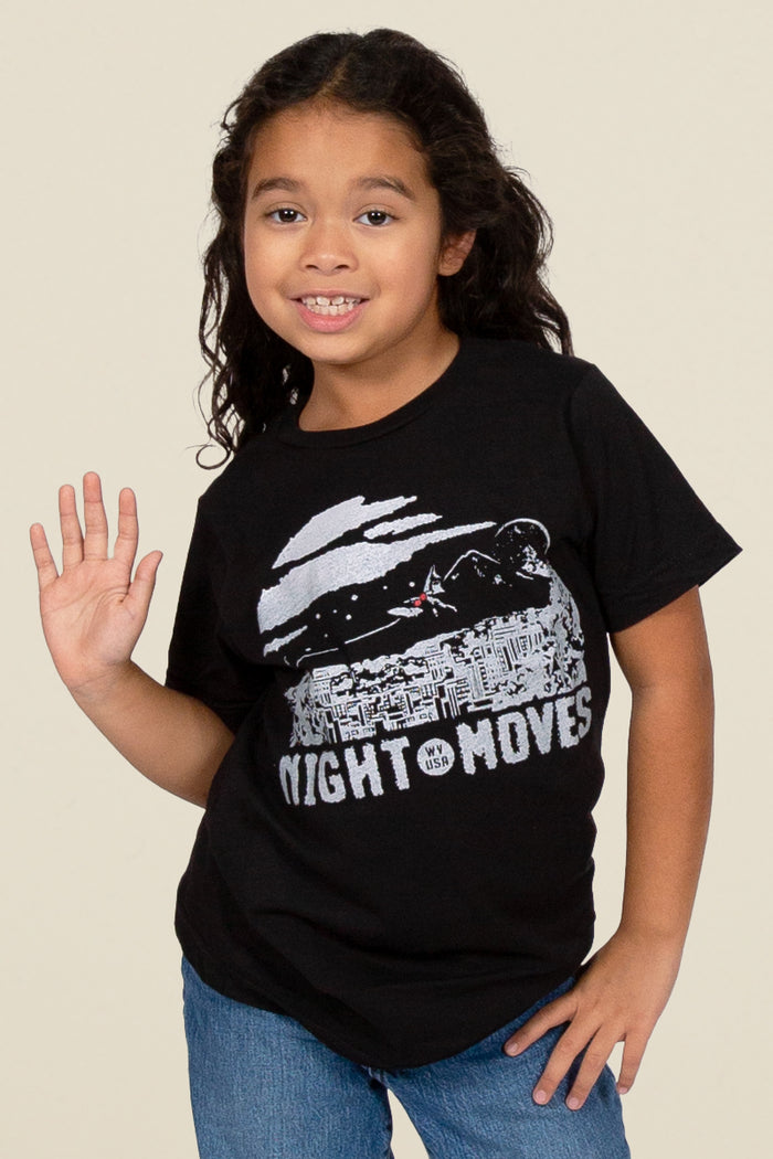 Kin Ship Goods black kids tee with ‘Night Moves USA’ moonlit cityscape and mothman silhouette graphic in white ink.