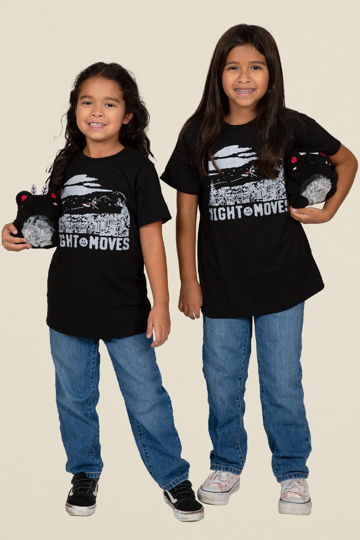 Kin Ship Goods black kids tee with ‘Night Moves USA’ moonlit cityscape and mothman silhouette graphic in white ink.