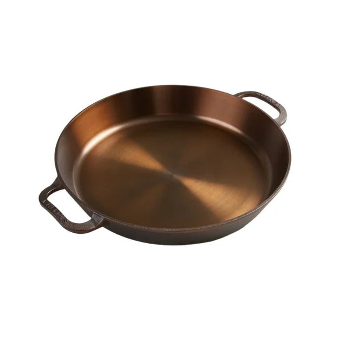 Smithey Ironware No. 14 dual handle cast iron skillet with a smooth cooking surface and sturdy handles on a kitchen countertop.