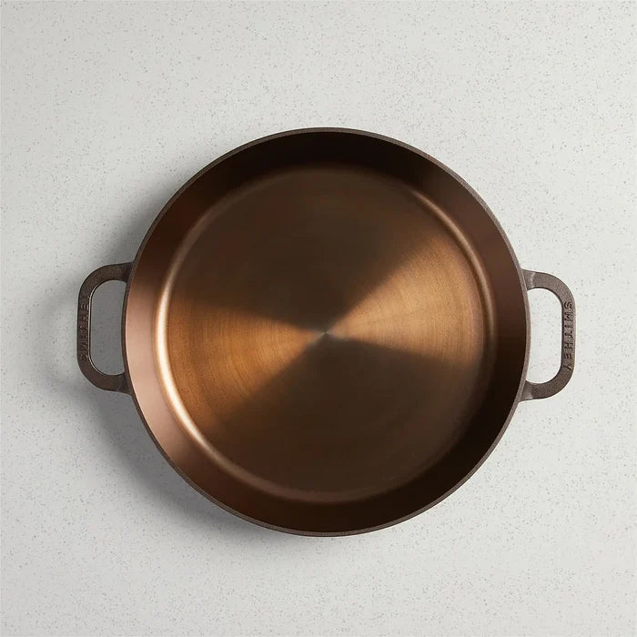 Smithey Ironware No. 14 dual handle cast iron skillet with a seasoned black finish and sturdy handles for versatile cooking.