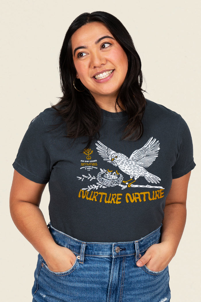 Kin Ship Goods black t-shirt with bird feeding chicks in a nest and 'Nurture Nature' message in golden yellow.