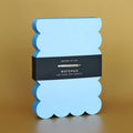 Scalloped Shaped Notepad in Aqua And Blue on a beige background at Addison West
