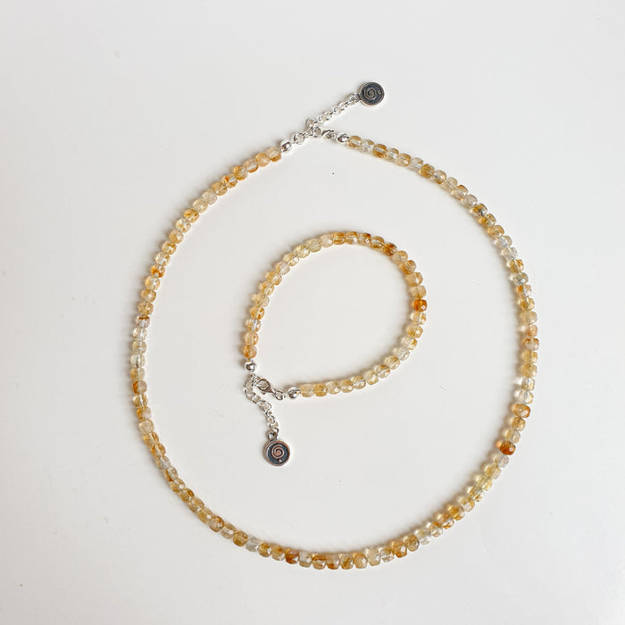 Beaded necklace with a silver clasp on a light gray background