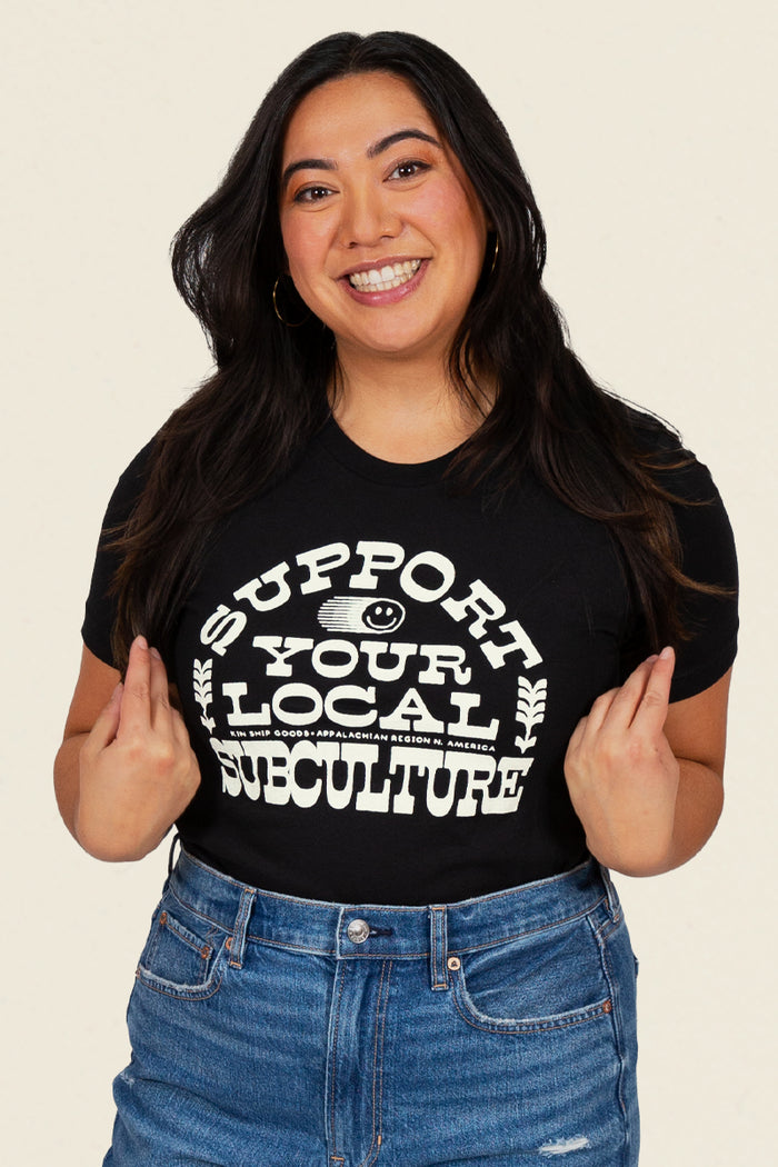 Kin Ship Goods black tee with bold white ‘Support Your Local Subculture’ text and smiley face graphic, Appalachian-made.