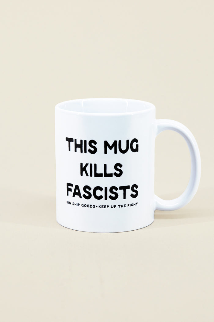 Kin Ship Goods white ceramic mug with 'This Mug Kills Fascists' text, inspired by Woody Guthrie's famous protest guitar.