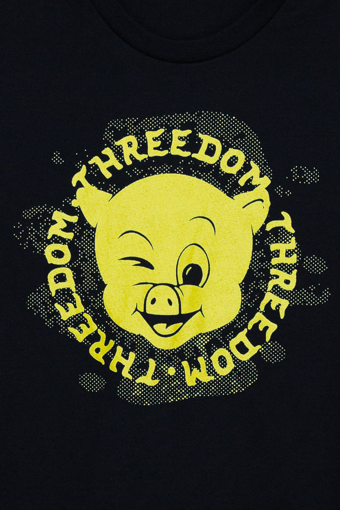 Kin Ship Goods black piss pigs tee with yellow winking pig face and repeating ‘Threedom’ text, official Comedy Bang! Bang! podcast collab.