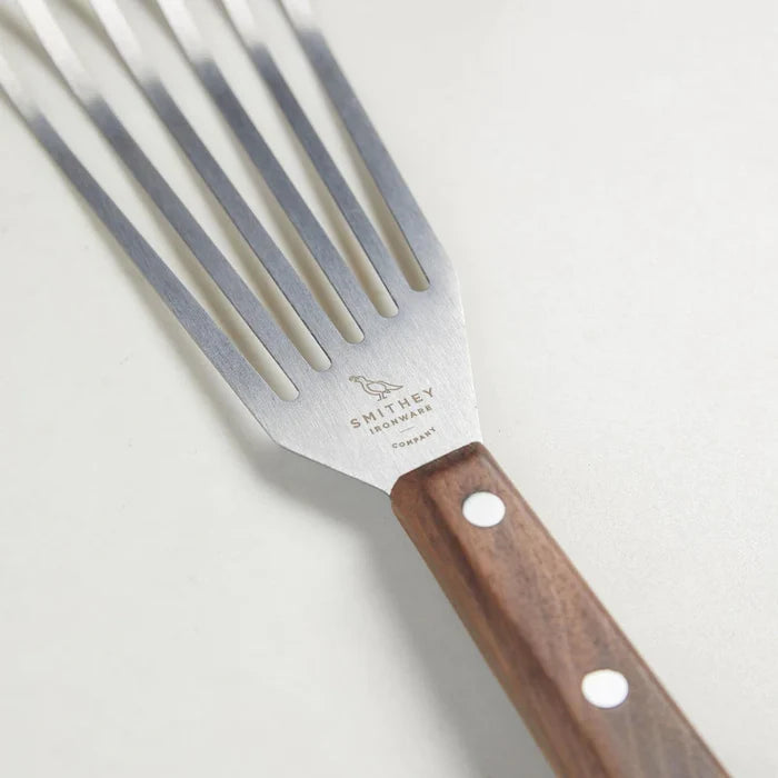 Smithey Ironware Walnut Handled Spatula from 1616 Cooking Utensils series, with a wooden handle and stainless steel spatula head.