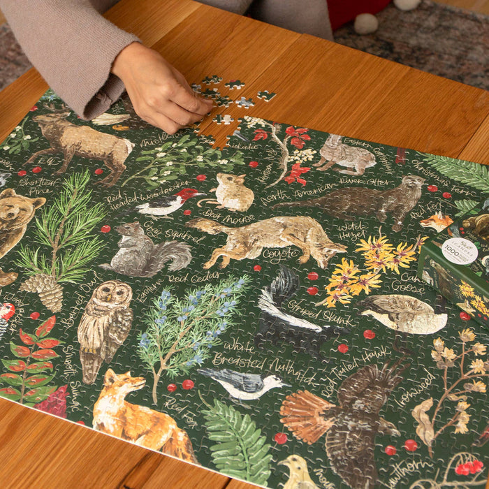 Winter Flora & Fauna 1,000 Piece Puzzle on a wood table at Addison West